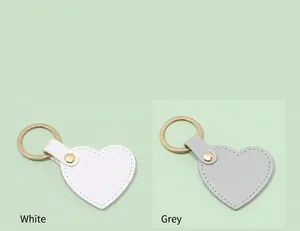 Detailed display of fashionable heart-shaped leather keychains in white and grey colors