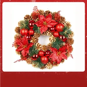 Detailed view of Christmas wreath featuring red poinsettias and gold pinecones