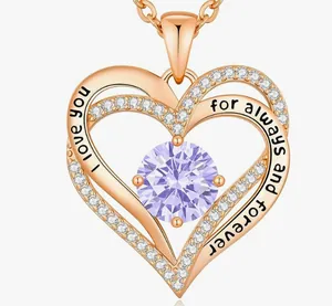 Close-up of rose gold double heart necklace with purple stone and love engraving
