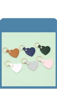 Close-up of heart-shaped leather keychains in various colors with gold rings