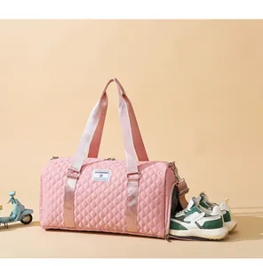 Pink quilted duffel bag with side shoe compartment detail for gym and travel use