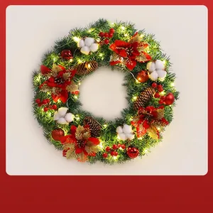 Detailed view of a Christmas wreath with LED lights, red flowers, and pine cones