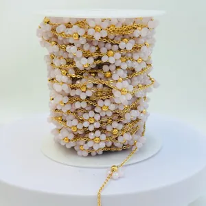 Close-up of handmade pale pink floral bead chain with vacuum gold plated links