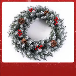 Detailed view of a snow-dusted Christmas wreath with pine cones and berries for doors