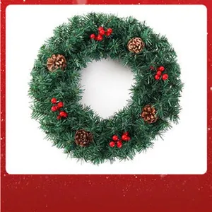 Detailed view of a green artificial Christmas wreath with pine cones and red berries