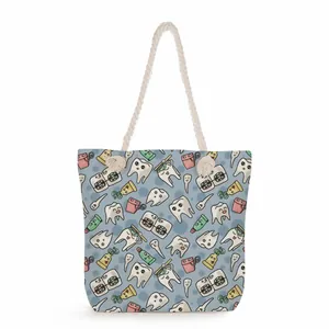 Close-up of a large capacity tote bag with a cute cartoon dental pattern and rope handles.