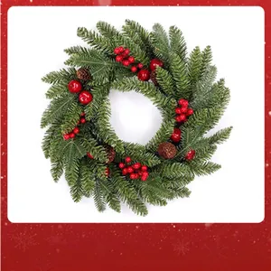 Close-up of a festive Christmas wreath with green pine needles, red berries, and pine cones.