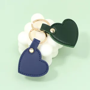 Stylish heart-shaped leather keychains in green and blue colors with gold rings