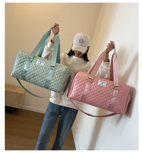 Model displaying light green and pink quilted duffle bags with detachable straps