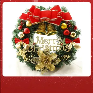 Close-up detail of a festive Christmas wreath with red ribbons and golden bells.