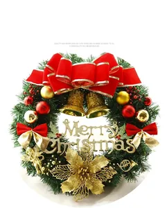Detailed macro view of a lush green Christmas wreath decorated with red bows and gold bells