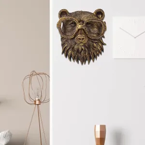 Close-up of a retro imitation copper bear head wall hanging with glasses decoration in a modern room