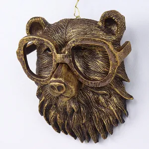Detail of vintage copper-finished bear head wall hanging with creative glasses design