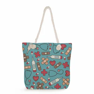 Large nurse themed printed canvas tote bag with medical patterns and rope handles.