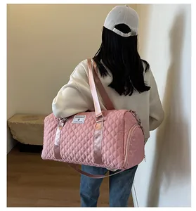 Pink quilted travel duffle bag with shoulder strap for sports or short trips