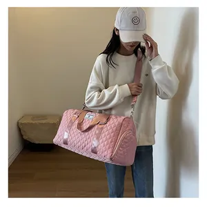 Pink quilted large capacity duffel bag shown on model for short-distance travel use