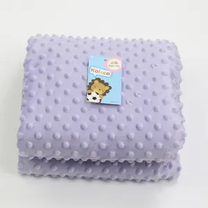 Macro detail of soft lavender dimple fleece baby blanket showing textured bubbles and brand tag