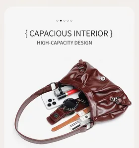 Detailed view showing the spacious interior of a pleated dark brown cloud shoulder bag