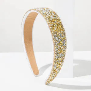 Close-up of a Baroque style gold and silver rhinestone wide headband for women