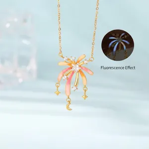 Close-up detail of firework-shaped pendant necklace with pink accents and luminous effect