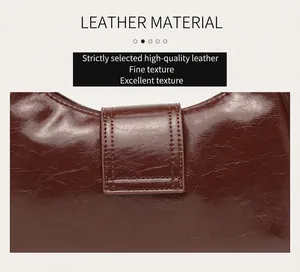 Close-up detail of high-quality brown textured leather on vintage cloud underarm bag.