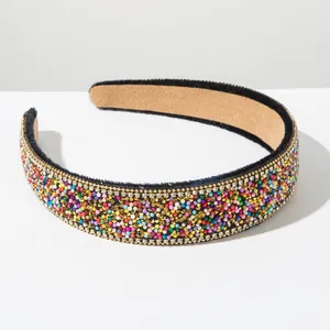 Detailed macro view of a Baroque wide headband with colorful rhinestones and gold studs