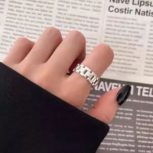 Stylish silver chain link interlocking ring with hollow design for a minimalist look.