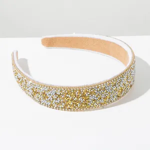 Close-up of sparkling gold and silver rhinestone Baroque style wide headband