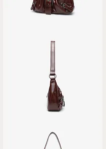 Side view detail of a dark burgundy retro pleated leather underarm bag with buckles
