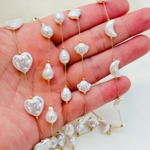 Detail of summer beach style necklace with heart, shell and crescent moon beads.