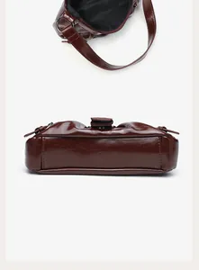 Detail view showing the interior and bottom of the brown pleated cloud shoulder bag