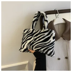 Close-up of stylish zebra print plush handbag with soft faux fur texture detail
