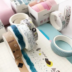 Creative Japanese washi tape set with geometric patterns on a grid notebook