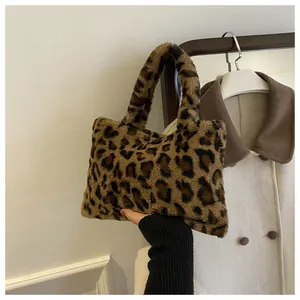 Detailed view of a stylish leopard print plush handbag featuring soft faux fur texture