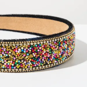 Close-up detail of a colorful beaded Baroque headband with sparkling rhinestones.