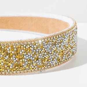 Close-up of Baroque style wide headband with sparkling yellow and silver rhinestones