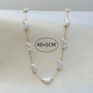 Detail of gold chain necklace with iridescent crescent moon charms, 40+5cm length