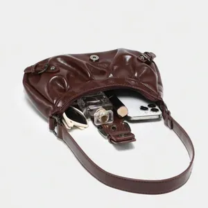 Vintage dark brown glossy leather pleated cloud underarm bag showing interior capacity