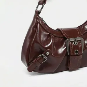 Retro burgundy pleated underarm cloud bag with high-shine metallic buckle detail for women