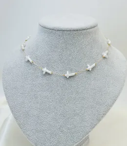 Elegant summer resort style necklace with freshwater pearl cross pendants on gold chain