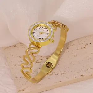 Elegant gold stainless steel heart bracelet watch featuring a sparkling rhinestone bezel