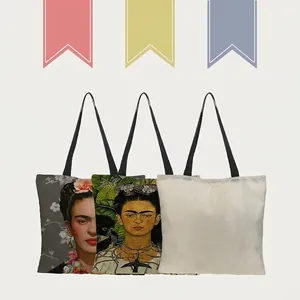 Detailed view of linen tote bags featuring artistic Frida Kahlo portrait prints.