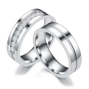 Elegant stainless steel couple rings set featuring channel-set sparkling cubic zirconia stones