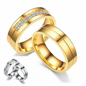 Elegant stainless steel couple rings with zirconia inlay and grooved gold finish design