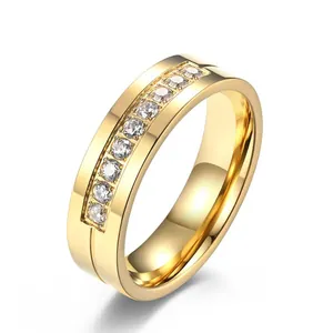 Detailed view of a gold-plated stainless steel ring with channel-set cubic zirconia gems.