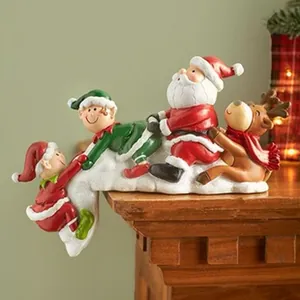 Detailed view of festive Christmas resin figurines featuring Santa and reindeer on mantel