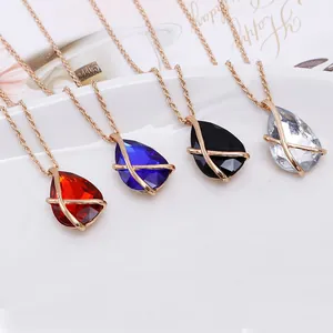 Detailed view of teardrop gemstone necklaces with gold-tone crisscross hollow cages.
