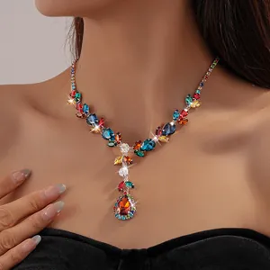 Close-up view of a colorful vintage zircon rhinestone leaf and teardrop necklace worn by a model