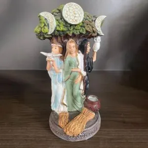 Macro view of a handcrafted Triple Goddess resin statue for home office decor.
