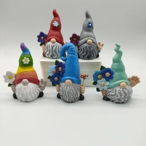 A set of five colorful resin garden gnome figurines holding flowers for home decoration